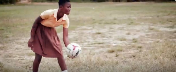 A schoolgirl plays soccer, video, Ghana agricultural union helps children leave work in cocoa production for school